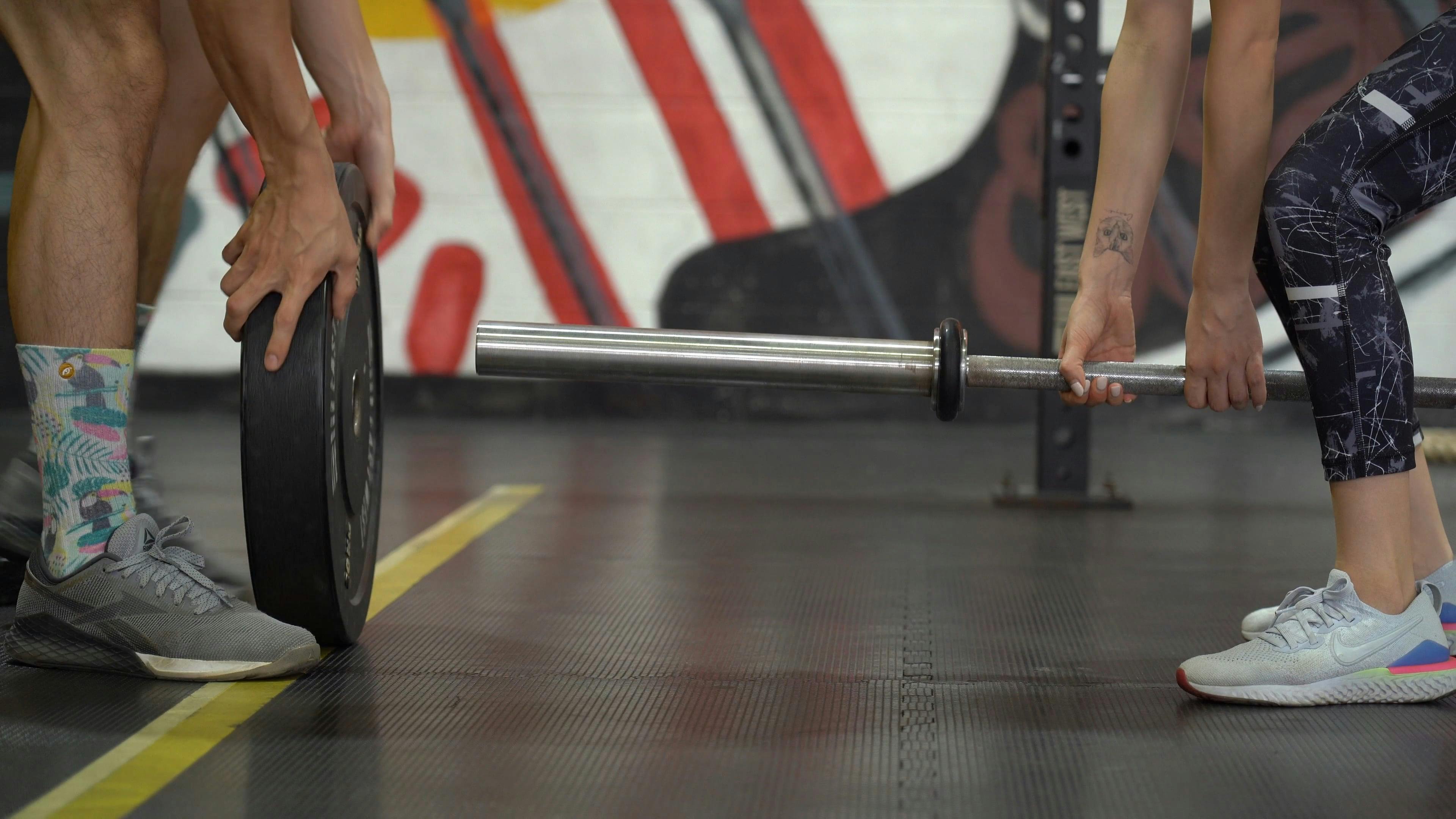 Putting Weights on a Barbell · Free Stock Video
