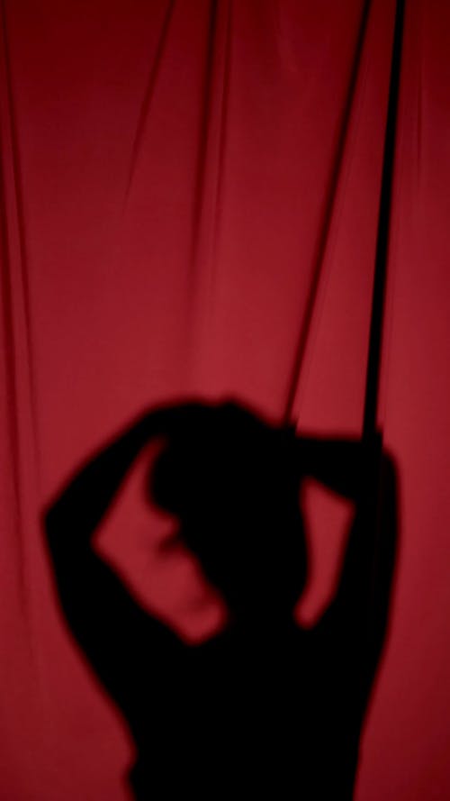 Woman Shadow on a Red Curtain