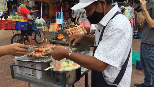 Man Selling a Street Food