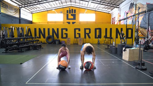 Man and Woman Exercising With Medicine Ball