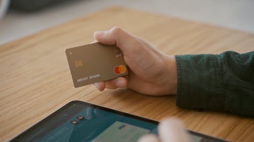 Close-Up View of a Person Holding His Mastercard