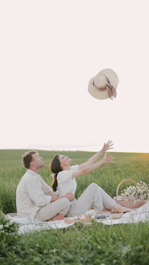 Couple Sweet Moments Together While Sitting on Picnic Blanket