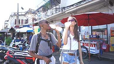 two women drinking a bottled water