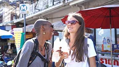 two women drinking bottled water for refreshment