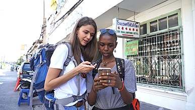 two women tourist using their smartphone to find directions