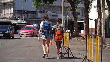 backside of women walking in the street