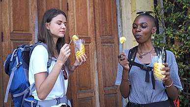 backpackers eating pineapple