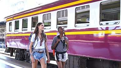 backpackers getting off the train