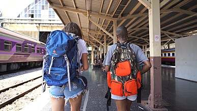 backpackers at a train station