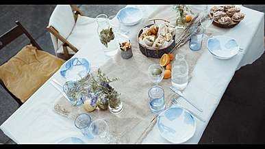a group of people sitting around a table with food