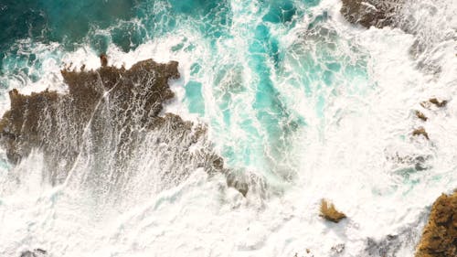 Top View of Sea Waves Crashing on Beach Shore