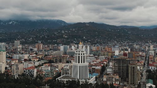 Drone Footage of City Buildings Under Cloudy Sky