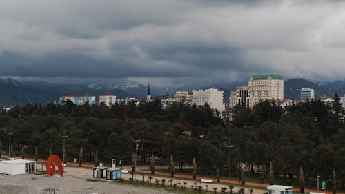 Drone Footage of City Buildings Under Cloudy Sky