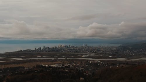 Drone View of Cityscape Under White Clouds