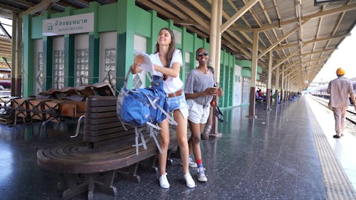 Two Women Walking on Railway Platform