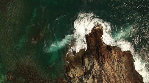 Top View of Sea Waves Crashing on Rock Formations