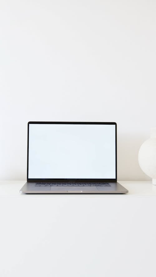 Laptop Computer on White Surface Against White Background
