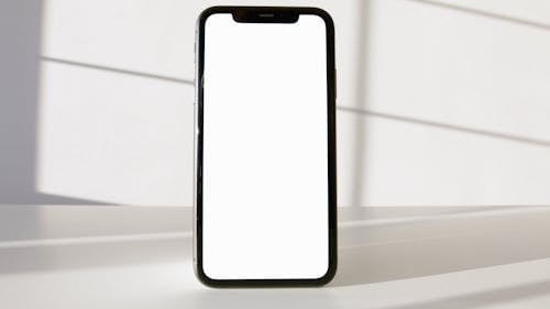 Smartphone on White Surface Against White Background