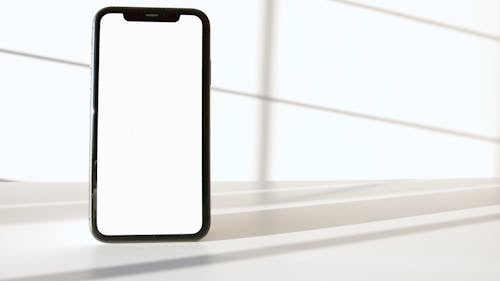 Smartphone on White Surface Against White Background