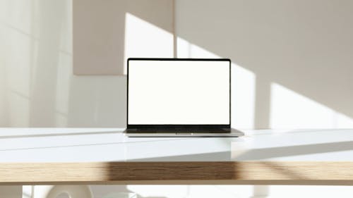 Laptop Computer on White Surface Against White Background