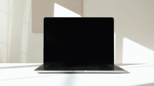 Laptop Computer on White Surface Against White Background