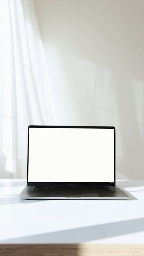 Laptop Computer on White Surface Against White Background