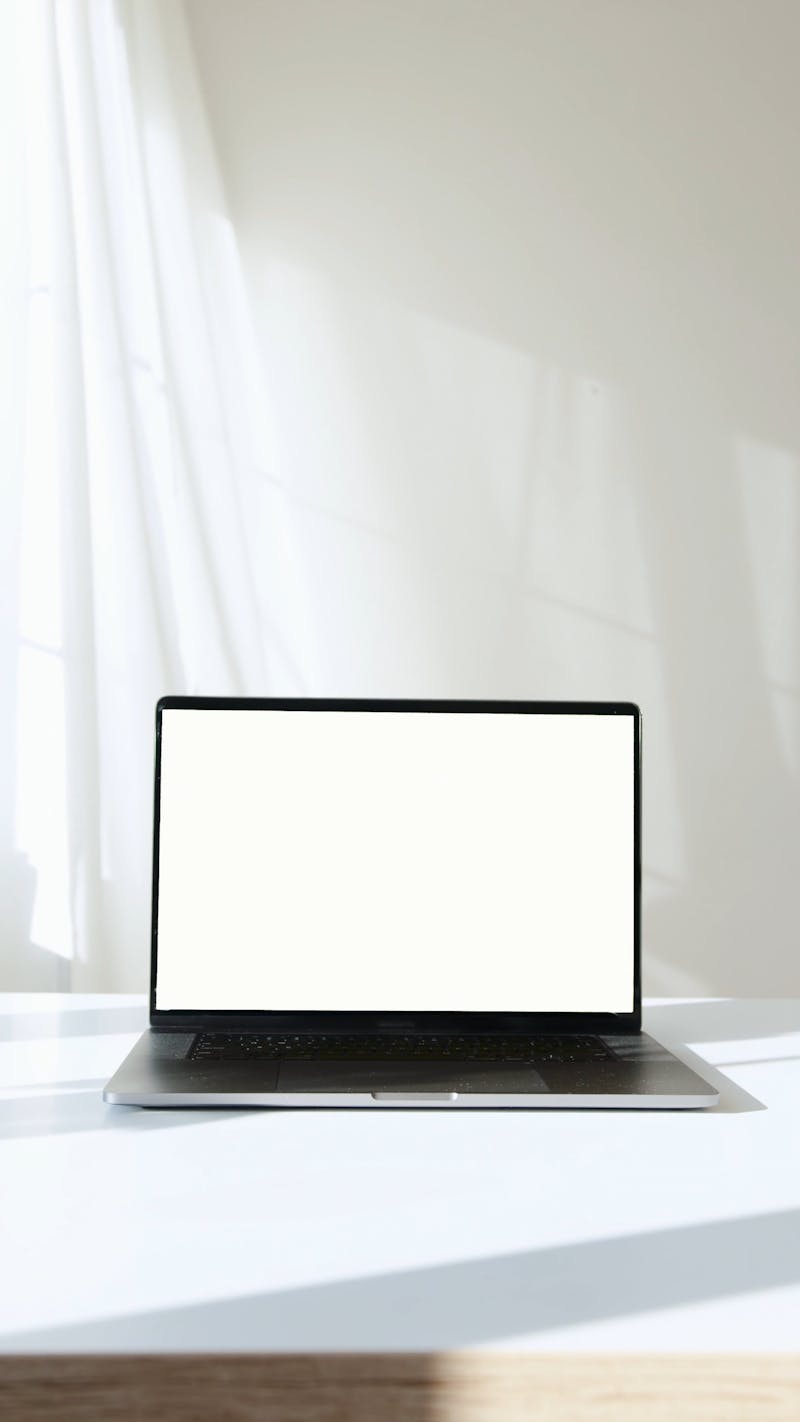 Laptop Computer on White Surface Against White Background Free Stock