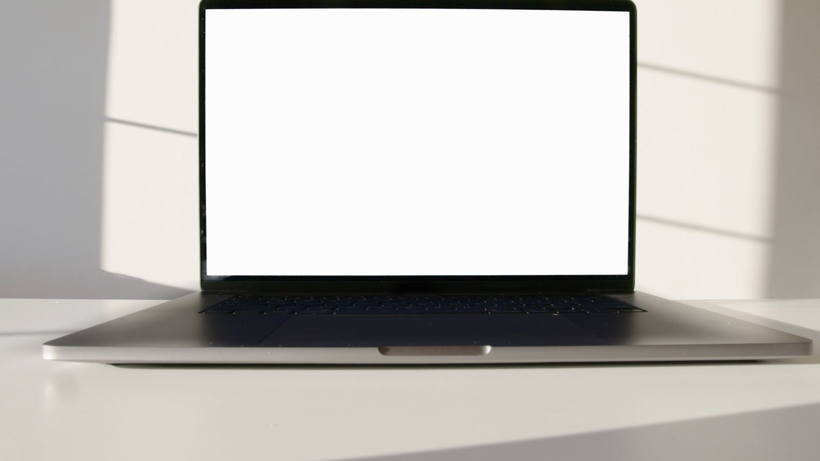 Laptop Computer on White Surface Against White Background Free Stock ...