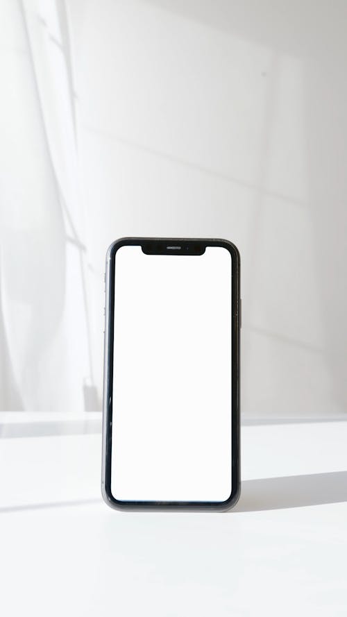 Smartphone on White Surface Against White Background