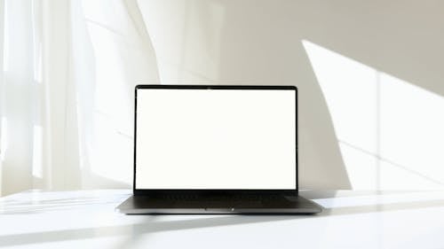 Laptop Computer on White Surface Against White Background