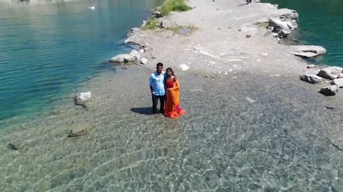 A Couple Standing On The lake side