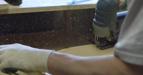 Person Using a Circular Saw in Making a Skateboard