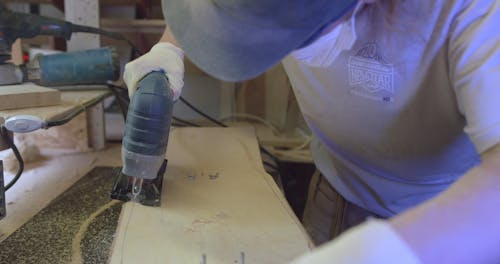 Man Using a Circular Saw in Making a Skateboard