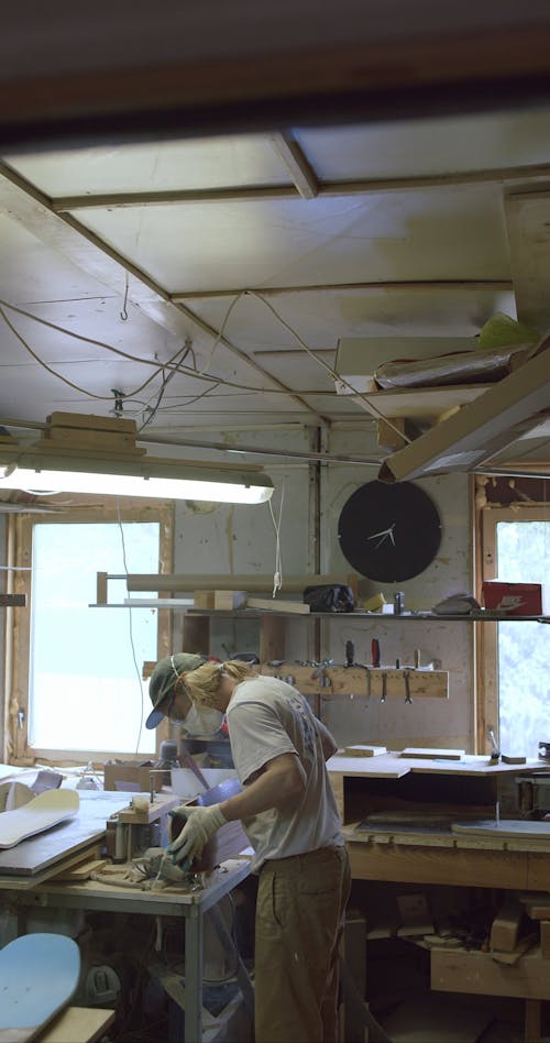 A Craftsman Shaping A Wood Into A Skateboard