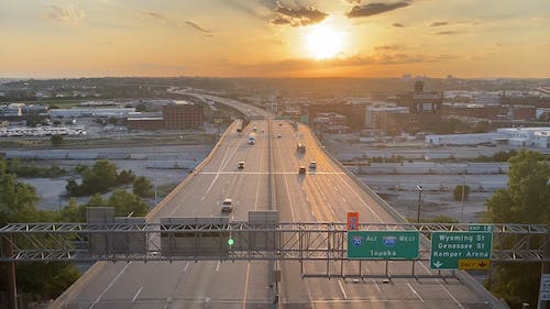 Bird's-Eye View of Vehicles Driving on Expressway During Golden Hour