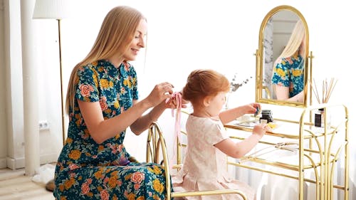 Mother Tying Her Daughter's Hair