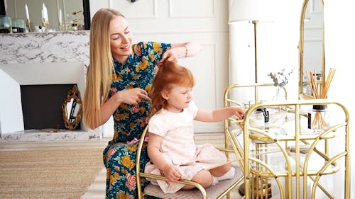 Mom Fixing Her Daughter's Hair