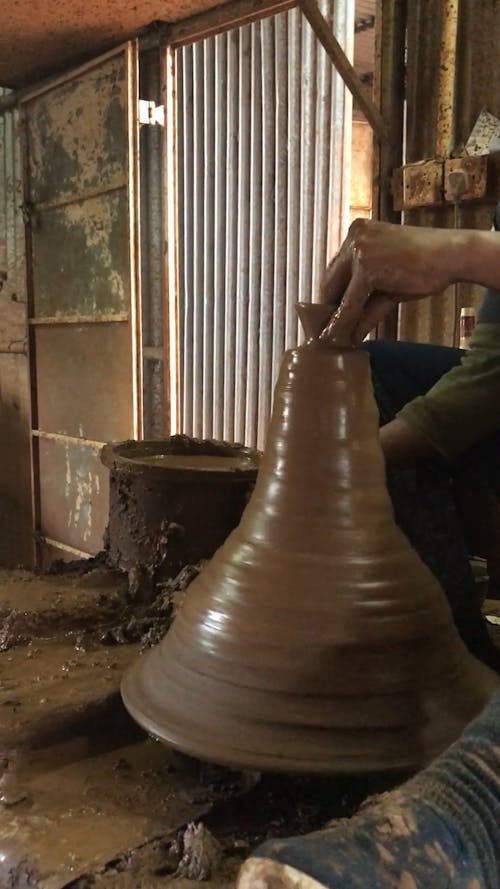 A Man Working In A Pottery Business