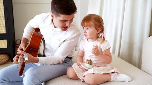 A Little Girl Singing a Song For Her Father