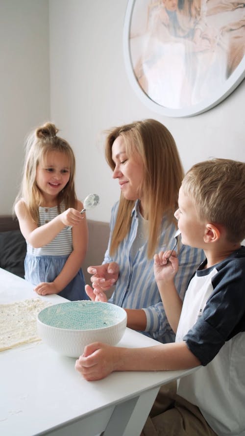 Kids Tasting The Cream Filling Using Spoons