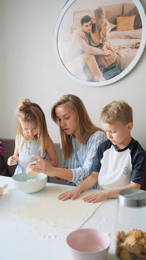 A Mom Showing Her Kids How To Make A Dough