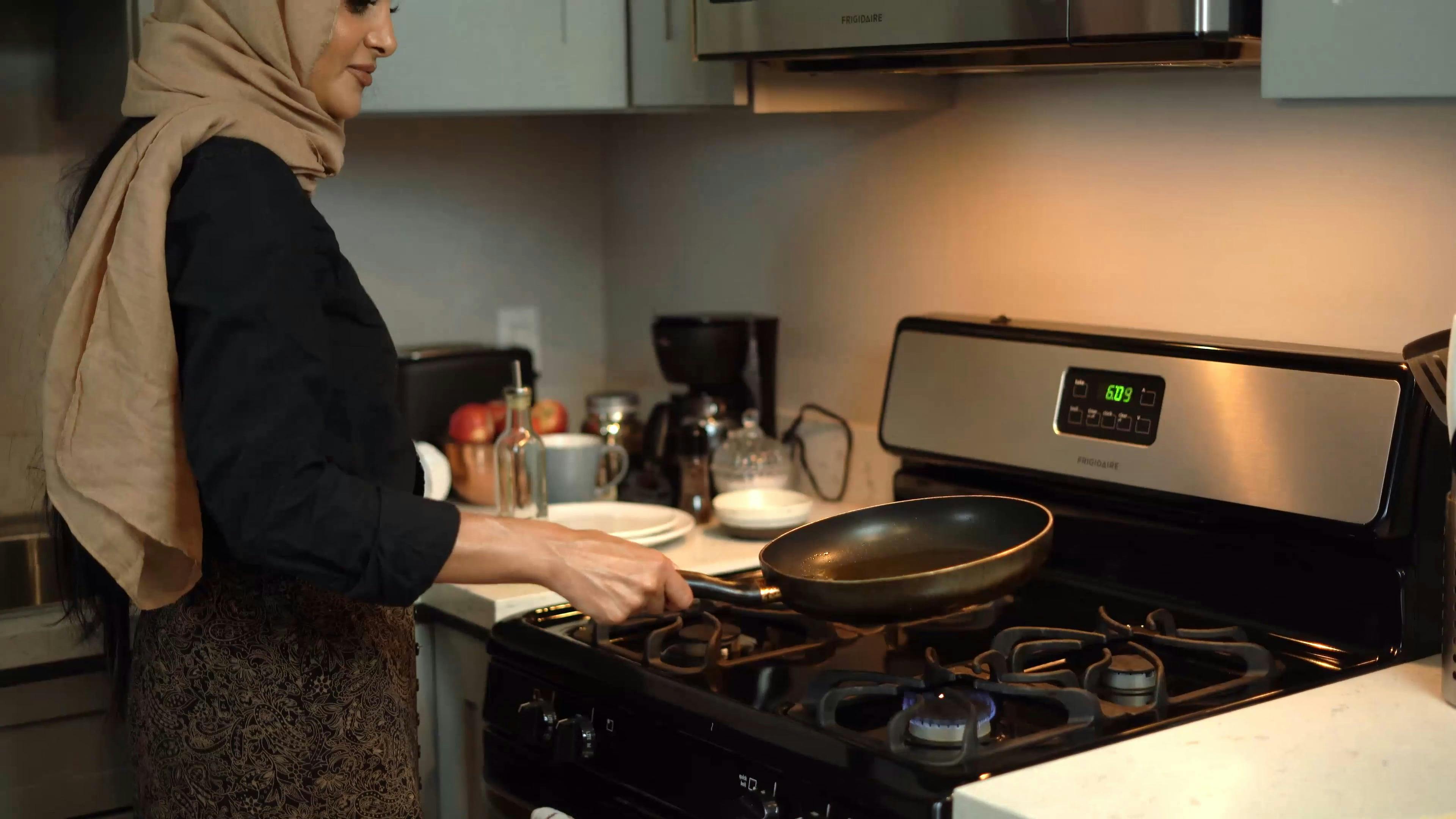A Woman Holding a Frying Pan and Heating the Oil \u00b7 Free Stock Video