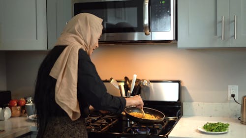 Woman in Hijab Cooking While Doing a Food Blog