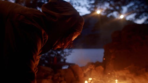 A Man Making A Fire In The Camp