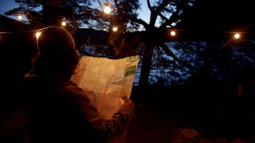 A Man Looking At A Map 