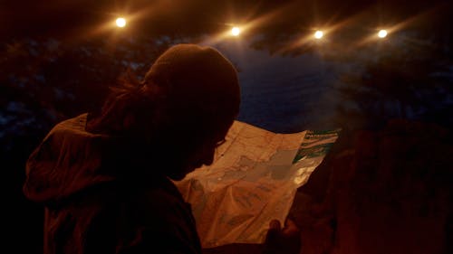 A Man Looking At A Map