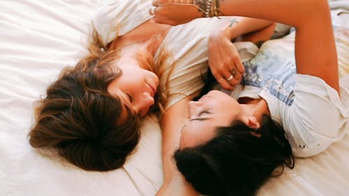 Two Women Kissing In Bed