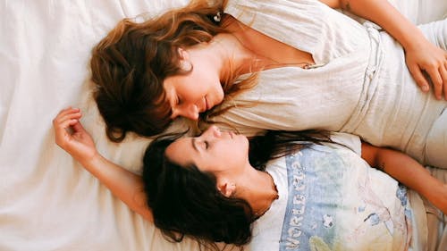 A Women Couple Lying In Bed