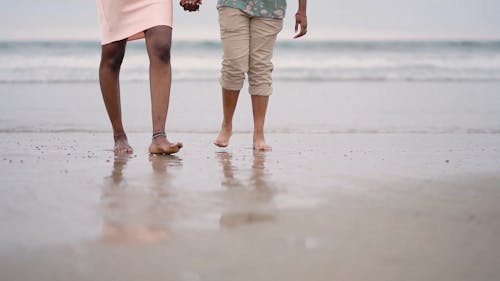 A Couple Walking In The Beach