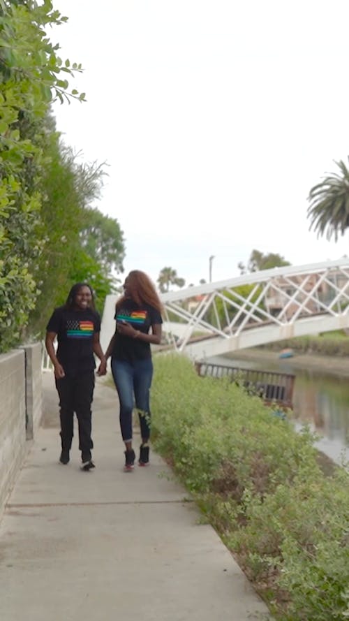 Women Couple Walking While Holding Hands